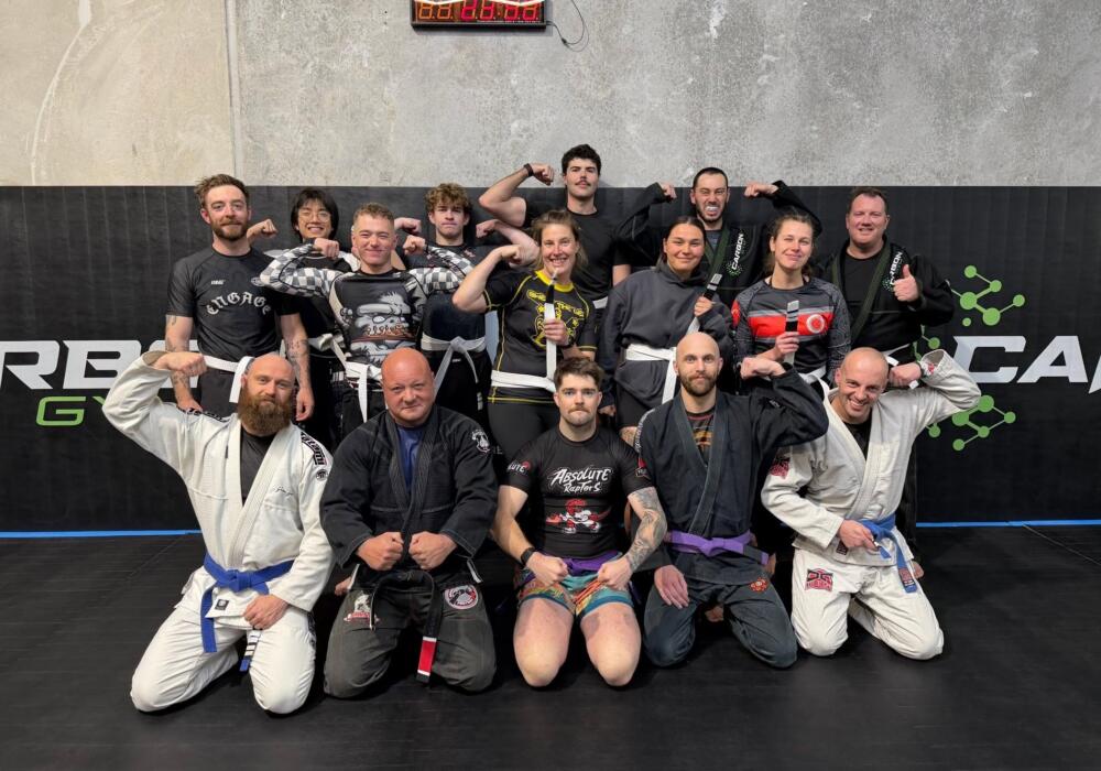 Brazilian jiu-jitsu class in gi and no-gi gear gathered on the mats after training at Carbon Gym Geelong