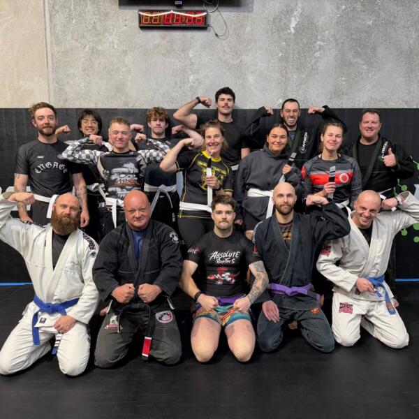 Brazilian jiu-jitsu class in gi and no-gi gear gathered on the mats after training at Carbon Gym Geelong