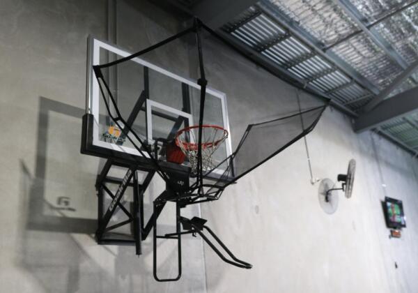 Wall-mounted basketball hoop with a ball return net at Carbon Gym Geelong