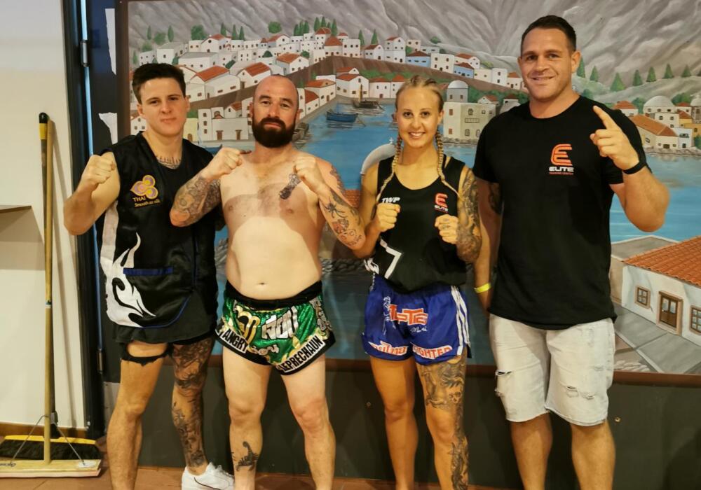 Stuart and Hannah from Carbon Gym posing together at a fight event