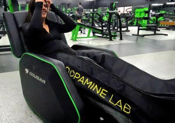 Member using compression recovery boots in a Dopamine Lab recliner at Carbon Gym Geelong