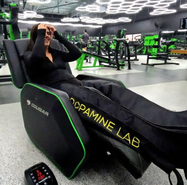 Member using compression recovery boots in a Dopamine Lab recliner at Carbon Gym Geelong