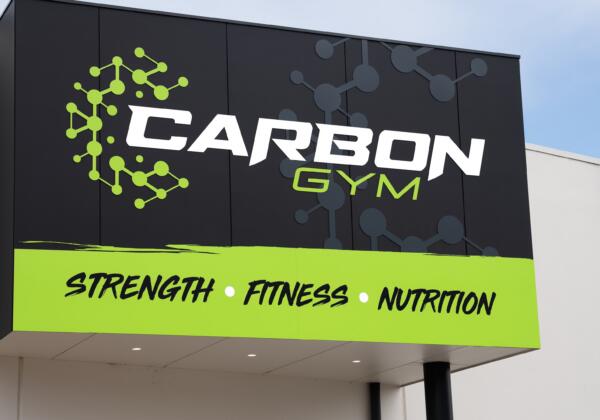 Carbon Gym exterior sign in Norlane Geelong featuring the carbon molecule logo and Strength Fitness Nutrition tagline