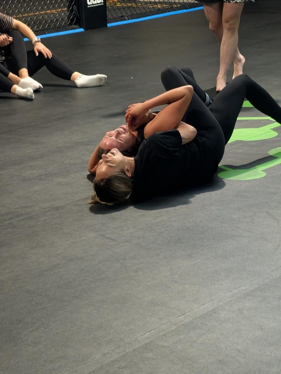 Two women practising the rear naked choke from back control at Carbon Gym Geelong