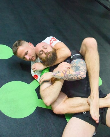 Two men training no-gi Brazilian Jiu-Jitsu at Carbon Gym in Geelong, one controlling his partner on the mats