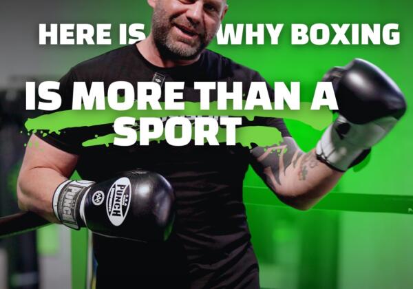 Boxing coach in gloves standing in the ring at Carbon Gym Geelong, with text overlay