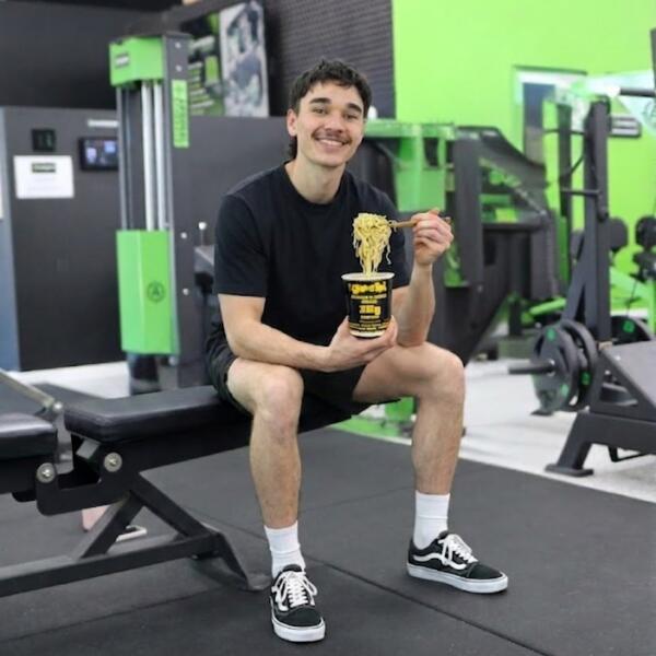 Weight management Geelong: Carbon Gym member refuelling with a high-protein noodle cup after training