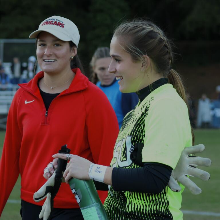 Heidi Harris sharing a laugh with a Columbus State teammate after a match