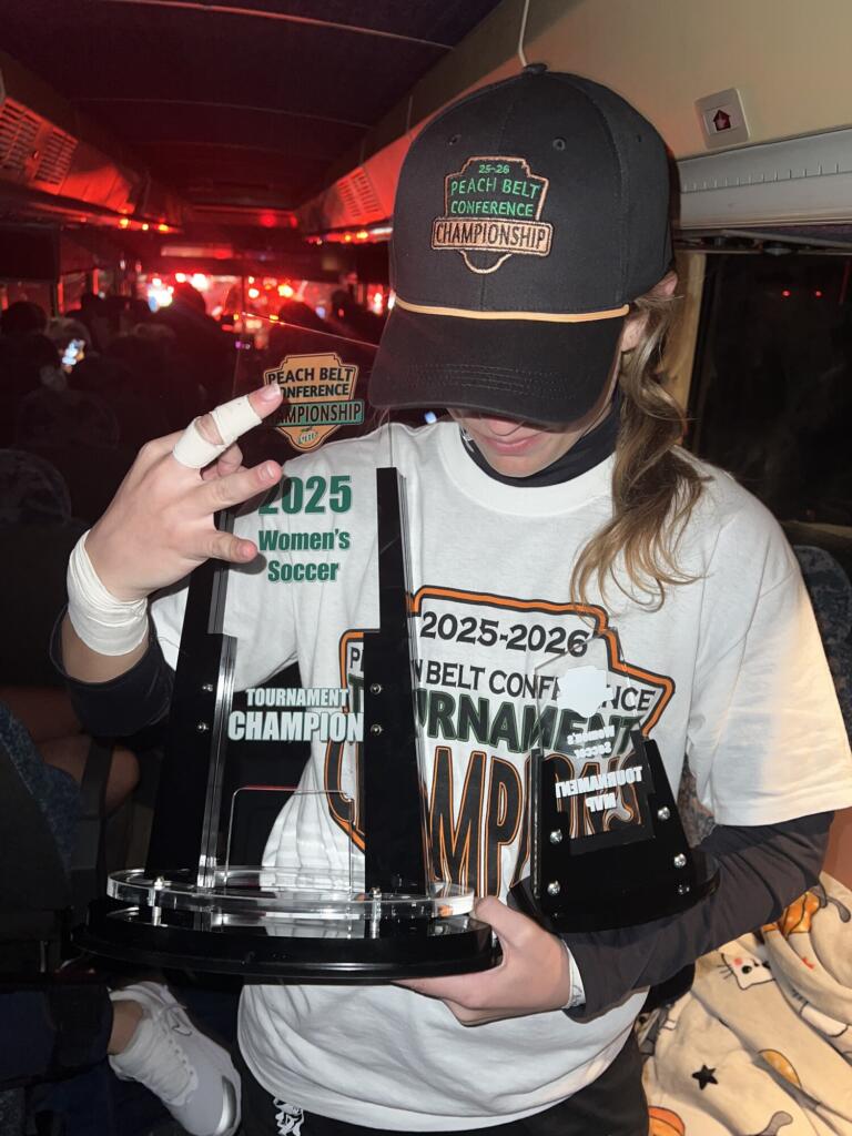Heidi Harris celebrating with the Peach Belt Conference Championship trophy